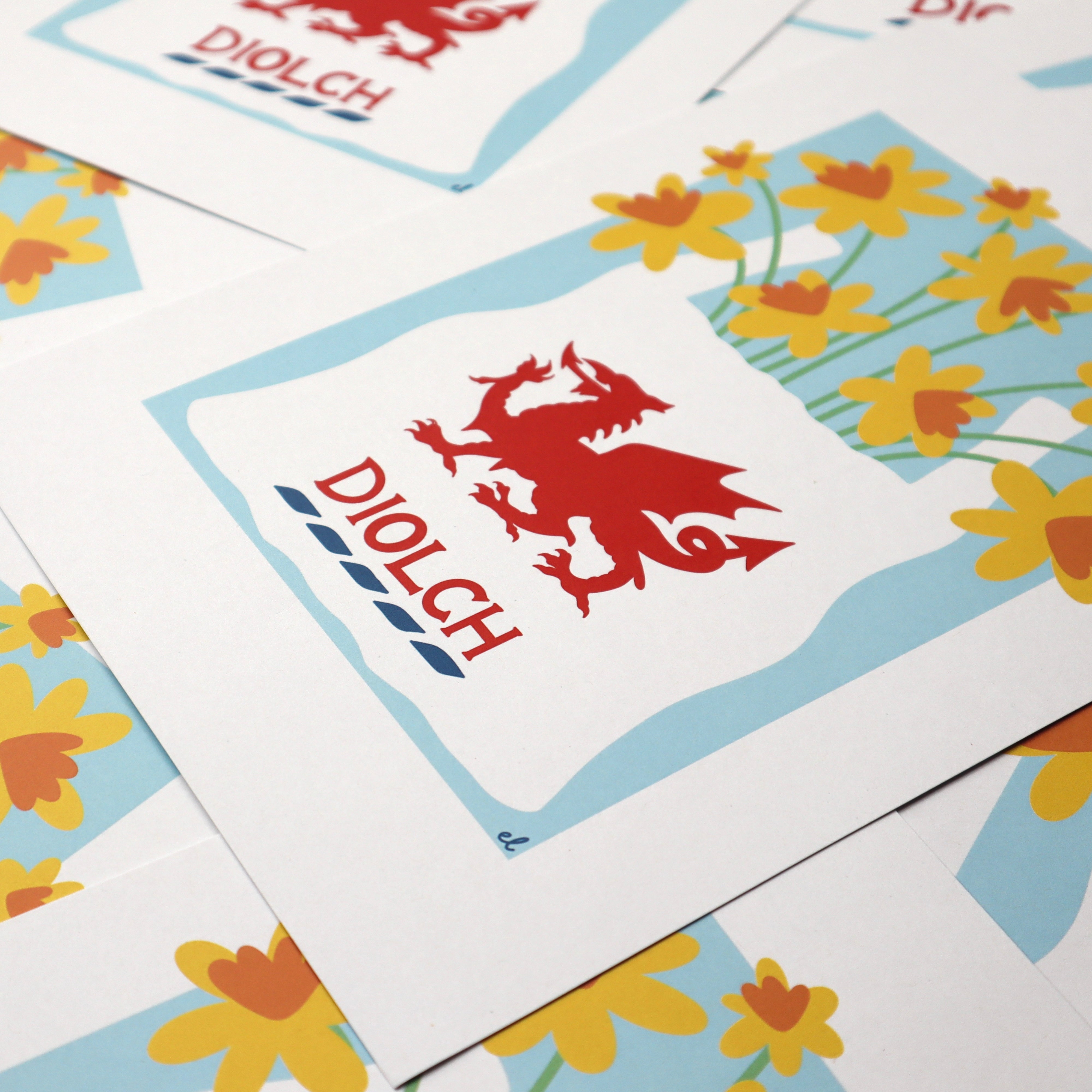 A colourful artwork depicting a carrier bag with a welsh dragon on full of daffodils, prints stacked overlapping